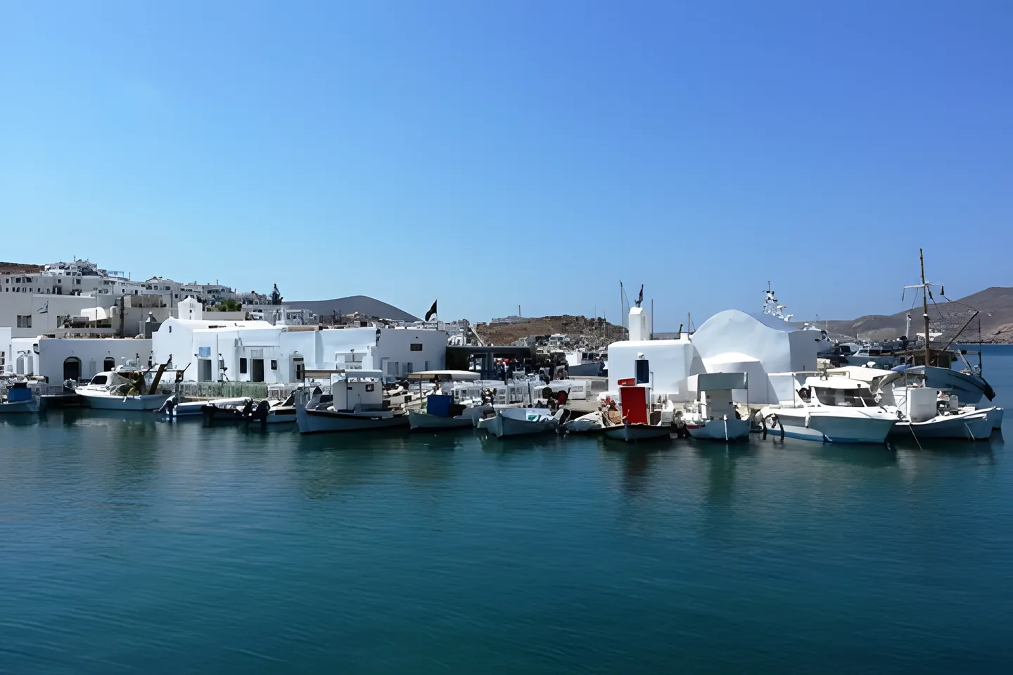 Whitewashed harbour with fishing boats in Paros